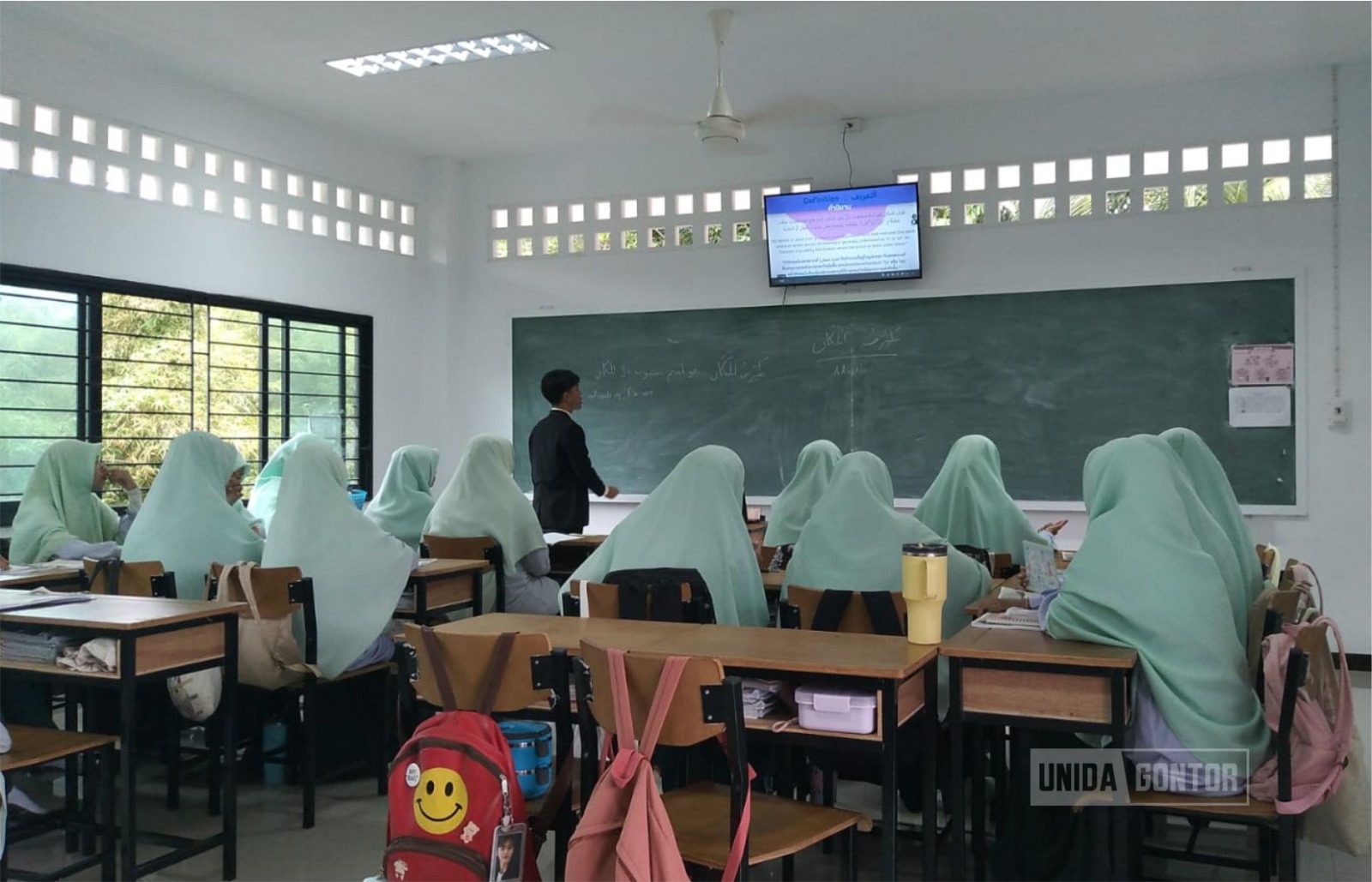 Students of the Faculty of Tarbiyah UNIDA Gontor teaching in a classroom during the Field Enrichment Practice program at an Islamic school in Pattani, Thailand.